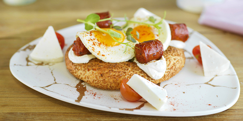Chorizo and fried eggs on traditional Greek bread